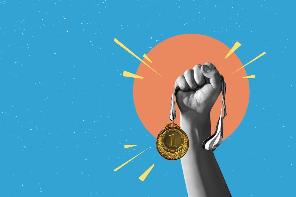 Person holding a medal.