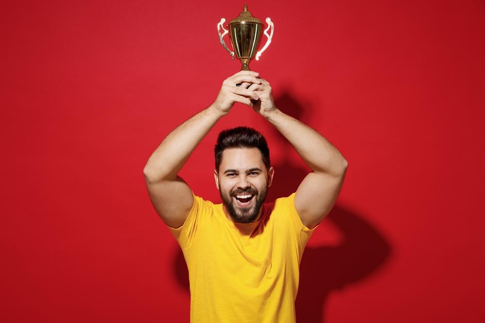 A man holding a personalized trophy.