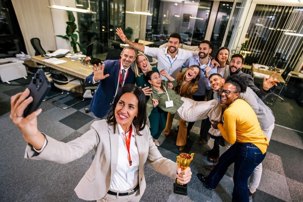 Coworkers celebrate success with an affordable award trophy