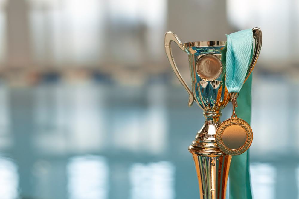 A trophy with a medal hanging on it.